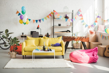 Interior of cozy room decorated with balloons and garland for party