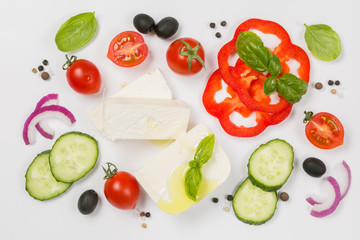 Healthy eating concept - selection of greek salad ingredients on white background