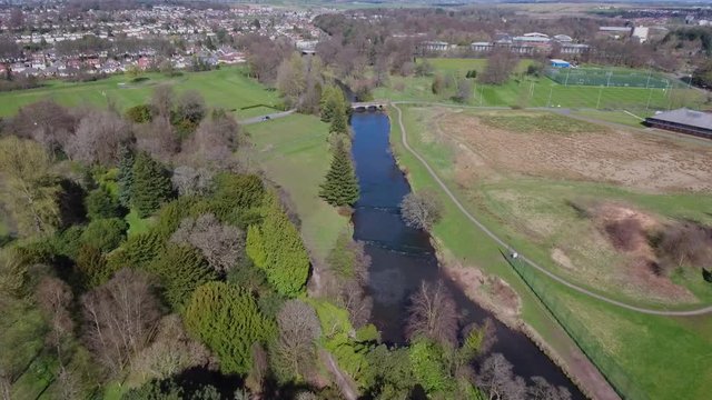 Aerial footage over Lady Campbell Bridge , River Kelvin and football pitches at Garscube Estate in Glasgow.