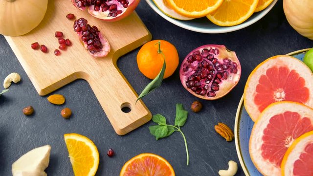 food, healthy eating and vegetarian concept - close up of fruits, nuts and vegetables on table top
