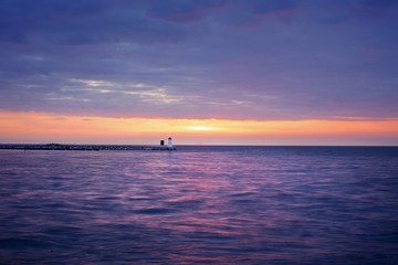 Naklejka na ściany i meble Sunset lighthouse sea sky clouds beach landscape spring sun