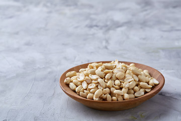 Pile of peelled peanuts isolated on white textured background, background, top view, close-up, selective focus