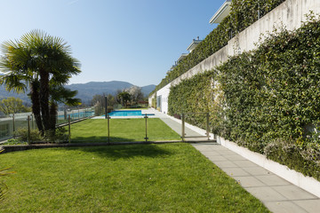 Exterior of building with swimming pool overlooking the hills