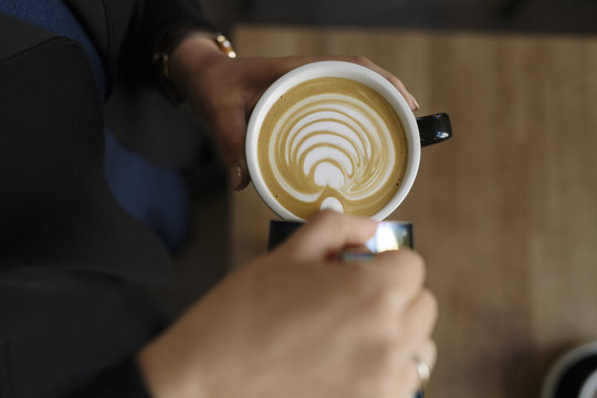 Barista Crafting Rosetta Latte Art in Coffee Cup with Expert Hands