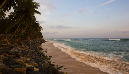 Seashore landscape. Sri Lanka during sea storm under heavy clouds as seen from the beach.