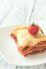 Portion of lasagne on the white plate