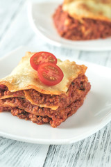 Portion of lasagne on the white plate