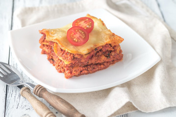 Portion of lasagne on the white plate