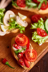 Breakfast still life with sandwiches, quail eggs, spicies and fresh fruits and vegetables, selective focus