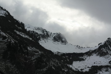 Obraz premium cold misty, foggy clouds on the mountains in the alps in Switzerland, Europe