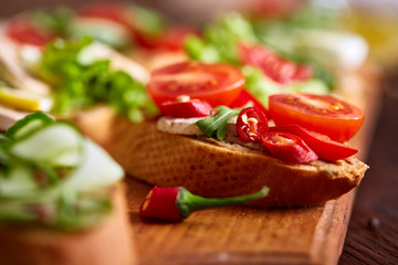 Breakfast sandwich with homemade paste, vegetables and fresh greens, shallow depth of field