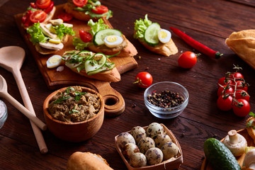 Breakfast still life with sandwiches, quail eggs, spicies and fresh fruits and vegetables, selective focus