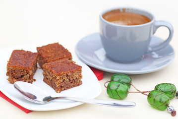 traditional greek coffee with pecan pie dessert and green rosary on the table