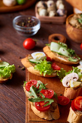 Breakfast sandwich with homemade paste, vegetables and fresh greens, shallow depth of field