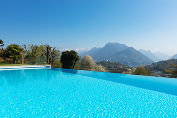 Exterior of building with swimming pool overlooking the hills