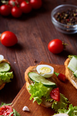 Breakfast sandwich with homemade paste, vegetables and fresh greens, shallow depth of field