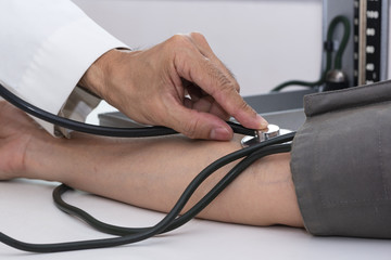 Doctor measuring blood pressure in medical office