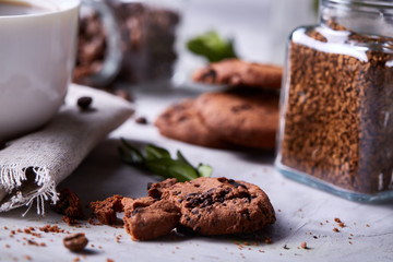 Breakfast background with mug of fresh coffee, homemade oatmeal cookies, grind coffee