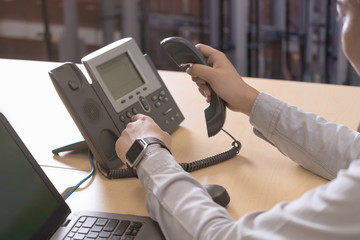 Businessman hand use telephone office, Selective focus.