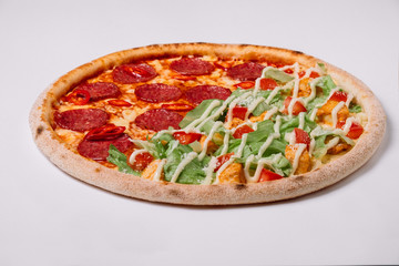 Pizza with salami and chicken isolated on white. Top view