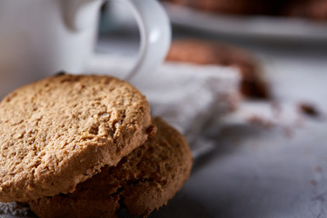 Breakfast background with mug of fresh coffee, homemade oatmeal cookies, grind coffee