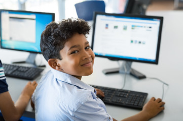 School boy using computer