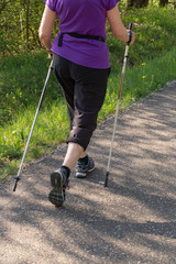 lady nordic walking in springtime park