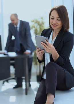 business woman with digital tablet on background of office.