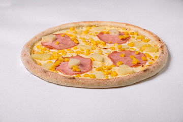 Pizza with ham, pineapple and corn isolated on white