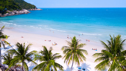 Tropical beach with people enjoy summer time at sandy coast line of koh Phangan island,Haad Rin area,Thailand