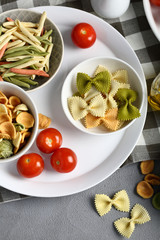 Uncooked pasta set and tomato