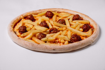 Pizza with meatballs and french fries isolated on white.