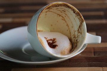 Fallen coffee cup with milk foam.