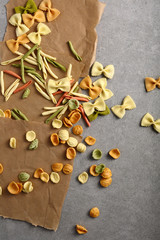 Raw pasta mix on gray background