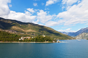 Montenegro. A picturesque view of the Boka Kotor Bay and the church on the hill (Pejina Crkva)