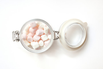 Beautiful white marshmallow in a glass jar. Marshemellou in a glass jar on a white background
