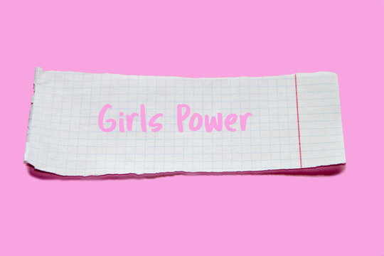 Naklejki Torn paper on pink background with text Girl Power. Ripped notebook sheet. Feminism concept