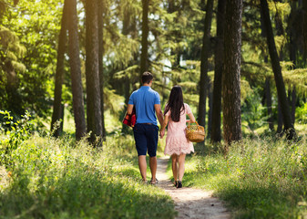 Fototapeta premium couple in love on dating holding hands and walkings in forest