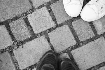 White and black sneakers on the road in black and white style