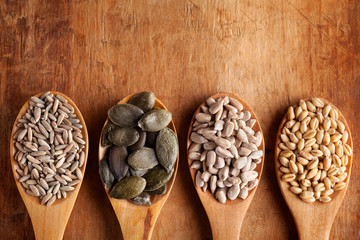 Grains, cereals and seed in wooden spoons. Sunflower seed, wheat, rye, secale, . Flat lay.