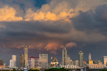 storm clouds above bangkok city with beautiful sunset light