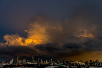 Fototapeta na wymiar storm clouds above bangkok city with beautiful sunset light