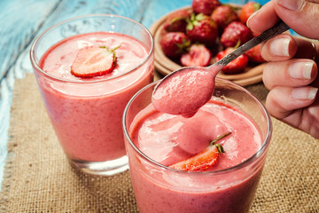 healthy strawberry yogurt with fresh berries on old wooden background