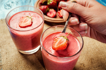healthy strawberry yogurt with fresh berries on old wooden background