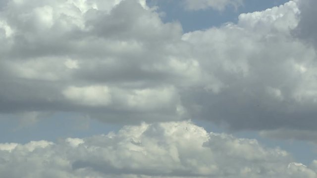 Timelapse of white clouds with blue sky in background.