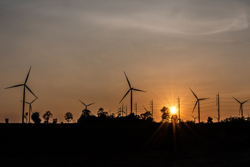 Wind turbine farm and agricultural fields with rays of light at sunset © ic36006