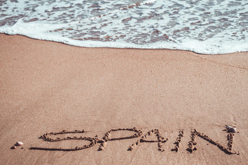 Spain written in the sand at the beach