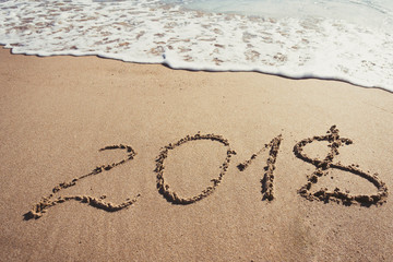 Number 2018 written on the sand in the beach