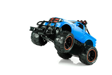 Blue RC SUV Off road truck car (Radio-controlled) take wheelie ready for race isolated on white background. (This toy has some dust from children playing)