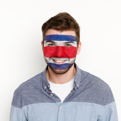 Young man with Costa Rica flag painted on his face